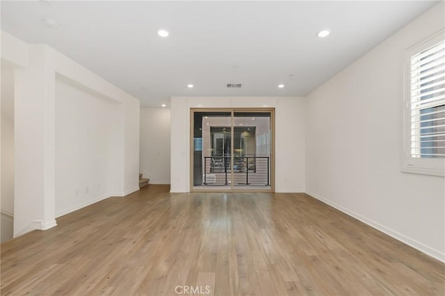 175 Cadence, Irvine, CA 92618 - spare room featuring light wood finished floors, baseboards, healthy amount of natural light, stairway, and recessed lighting