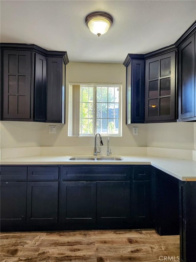 4297 Moonstone Dr, Los Angeles, CA 90032 - kitchen with a sink, wood finished floors, glass insert cabinets, and light countertops