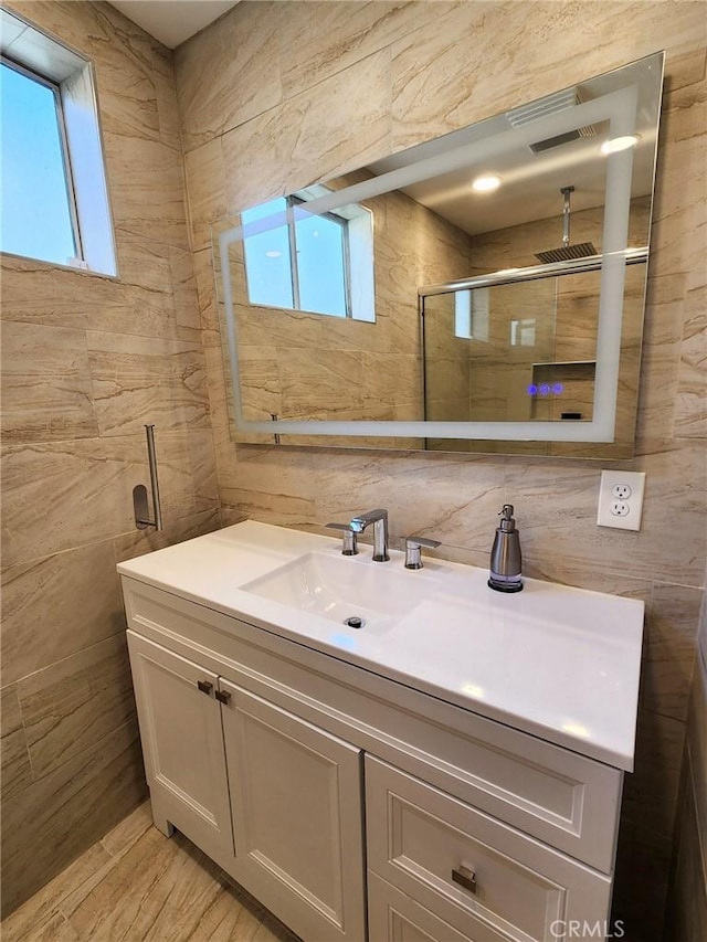 4297 Moonstone Dr, Los Angeles, CA 90032 - bathroom with tile walls, vanity, a shower, and wood finished floors