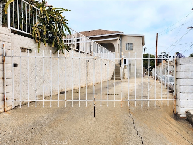 4297 Moonstone Dr, Los Angeles, CA 90032 - rear view of house with stucco siding and stairs