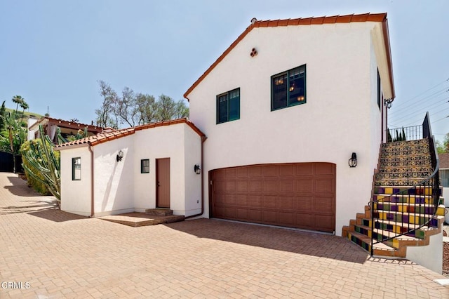 422 Foothill Dr, Fillmore, CA 93015 - mediterranean / spanish home featuring stairs, a garage, stucco siding, and decorative driveway