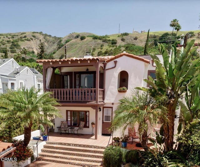 422 Foothill Dr, Fillmore, CA 93015 - back of house featuring a balcony, stucco siding, a mountain view, and a patio area