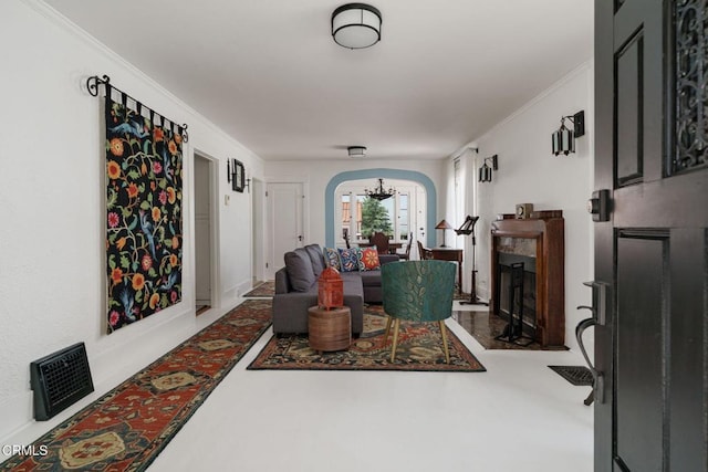 422 Foothill Dr, Fillmore, CA 93015 - living room with arched walkways, a chandelier, and ornamental molding