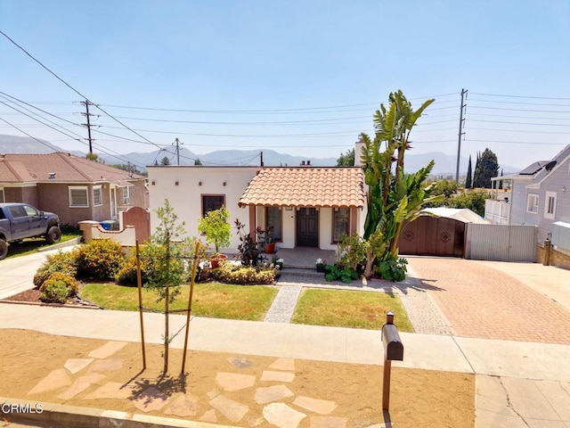 422 Foothill Dr, Fillmore, CA 93015 - view of front facade with decorative driveway, a tile roof, a gate, stucco siding, and a porch