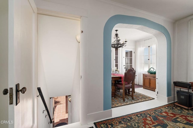 422 Foothill Dr, Fillmore, CA 93015 - hall with arched walkways, a chandelier, crown molding, and baseboards
