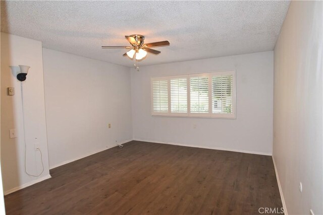 5369 Algarrobo Unit 1G, Laguna Woods, CA 92637 - spare room featuring a ceiling fan, dark wood finished floors, a textured ceiling, and baseboards