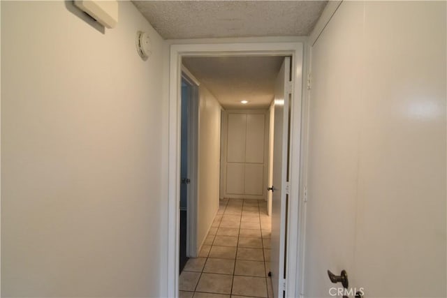 5369 Algarrobo Unit 1G, Laguna Woods, CA 92637 - hallway featuring light tile patterned floors and a textured ceiling