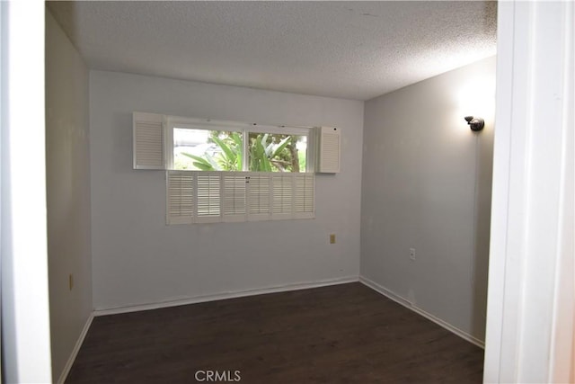 5369 Algarrobo Unit 1G, Laguna Woods, CA 92637 - empty room featuring a textured ceiling, dark wood-type flooring, and baseboards