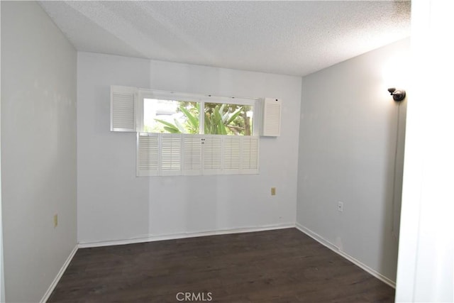 5369 Algarrobo Unit 1G, Laguna Woods, CA 92637 - empty room featuring a textured ceiling, wood finished floors, and baseboards