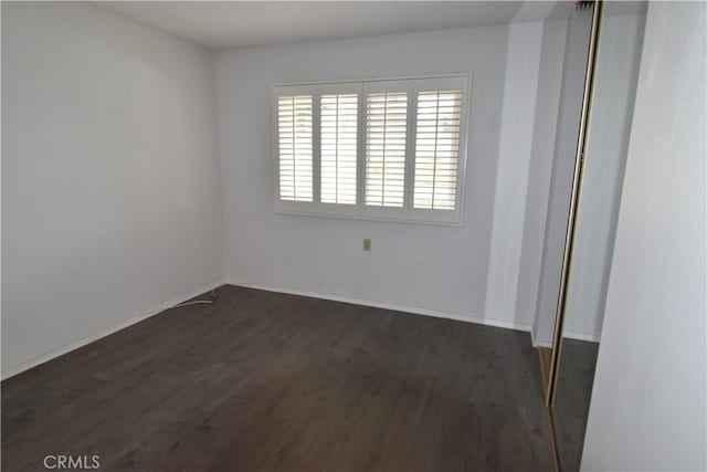 5369 Algarrobo Unit 1G, Laguna Woods, CA 92637 - unfurnished room featuring dark wood finished floors and baseboards