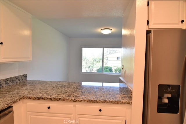 5369 Algarrobo Unit 1G, Laguna Woods, CA 92637 - kitchen with refrigerator with ice dispenser, white cabinets, and light stone countertops