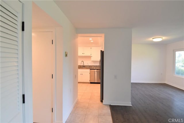 5369 Algarrobo Unit 1G, Laguna Woods, CA 92637 - corridor with baseboards and light wood-style flooring