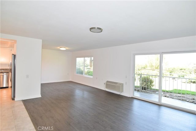 5369 Algarrobo Unit 1G, Laguna Woods, CA 92637 - unfurnished living room featuring a wall mounted AC and wood finished floors