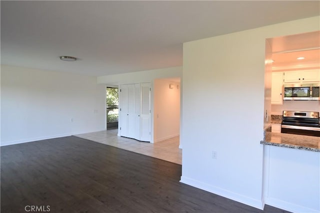 5369 Algarrobo Unit 1G, Laguna Woods, CA 92637 - unfurnished living room with dark wood finished floors and baseboards
