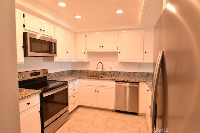 5369 Algarrobo Unit 1G, Laguna Woods, CA 92637 - kitchen with appliances with stainless steel finishes, light tile patterned floors, white cabinets, light stone countertops, and recessed lighting