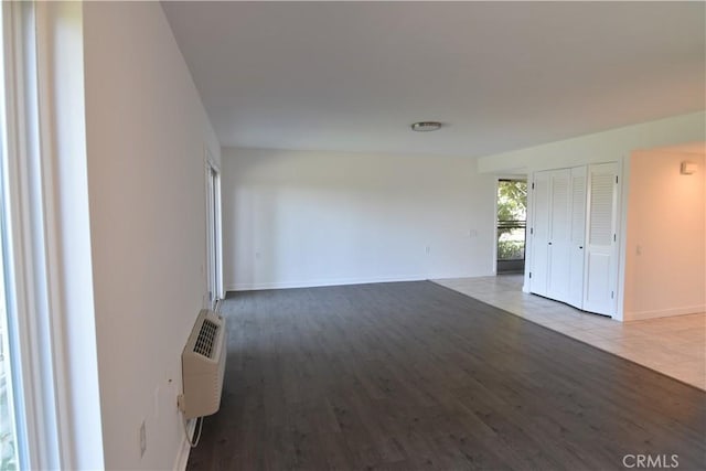 5369 Algarrobo Unit 1G, Laguna Woods, CA 92637 - spare room featuring wood finished floors and an AC wall unit