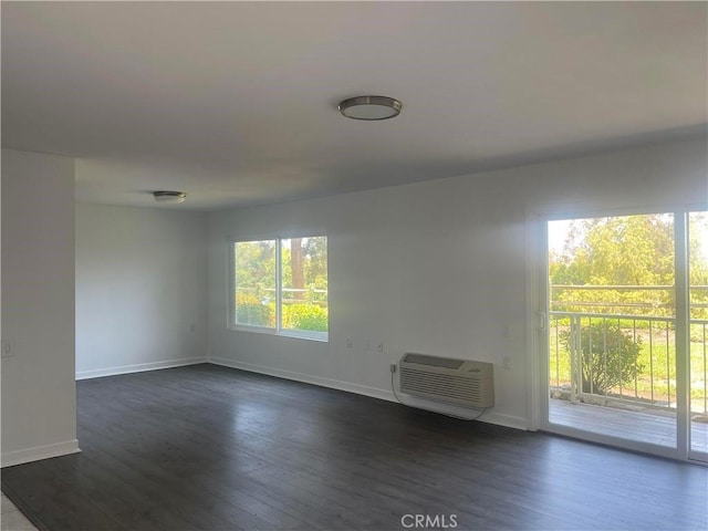5369 Algarrobo Unit 1G, Laguna Woods, CA 92637 - unfurnished room with dark wood-style flooring and a wall mounted air conditioner