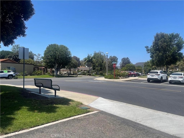 5369 Algarrobo Unit 1G, Laguna Woods, CA 92637 - view of asphalt street with traffic signs, sidewalks, and street lights