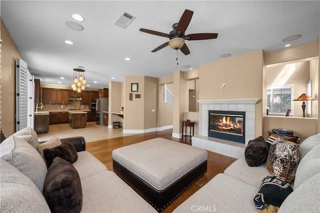 29012 Madrid Pl, Castaic, CA 91384 - living area featuring ceiling fan, light wood-style flooring, recessed lighting, a fireplace, and baseboards
