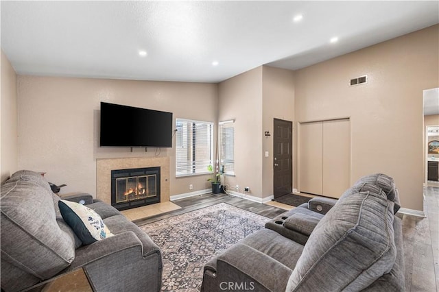 4846 Karling Pl, Palmdale, CA 93552 - living room with wood finished floors, baseboards, recessed lighting, a tiled fireplace, and vaulted ceiling