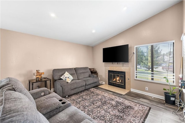 4846 Karling Pl, Palmdale, CA 93552 - living room featuring lofted ceiling, wood finished floors, a tiled fireplace, baseboards, and recessed lighting