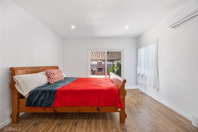 7037 Cimarron St, Los Angeles, CA 90047 - bedroom featuring a wall mounted air conditioner, wood finished floors, and recessed lighting