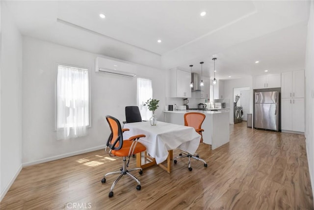 7037 Cimarron St, Los Angeles, CA 90047 - home office with a wall unit AC, light wood-style floors, recessed lighting, and independent washer and dryer