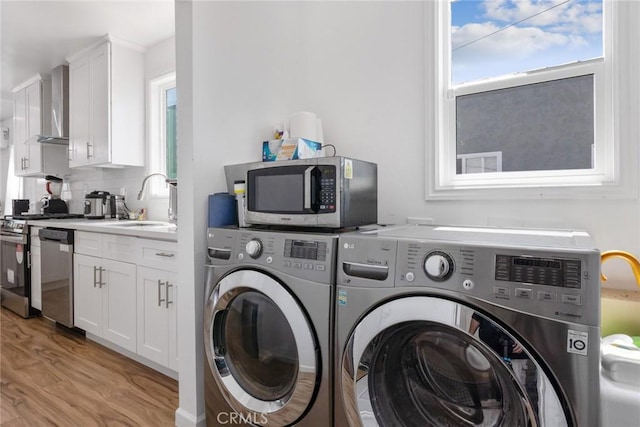 7037 Cimarron St, Los Angeles, CA 90047 - laundry area with independent washer and dryer, light wood-style flooring, and plenty of natural light