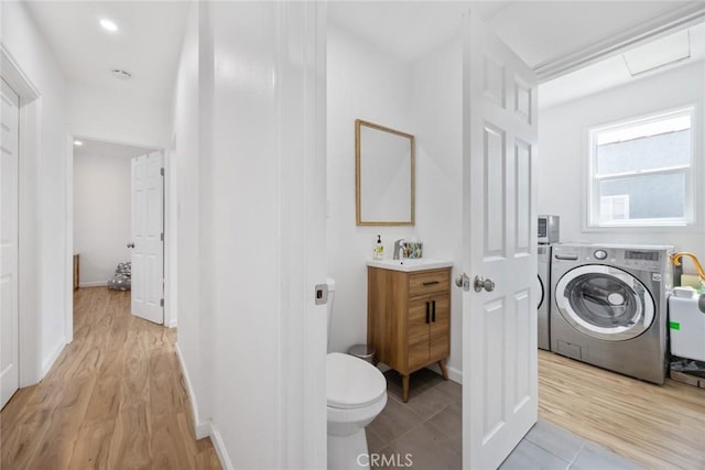 7037 Cimarron St, Los Angeles, CA 90047 - bathroom with washer / clothes dryer, vanity, and wood finished floors