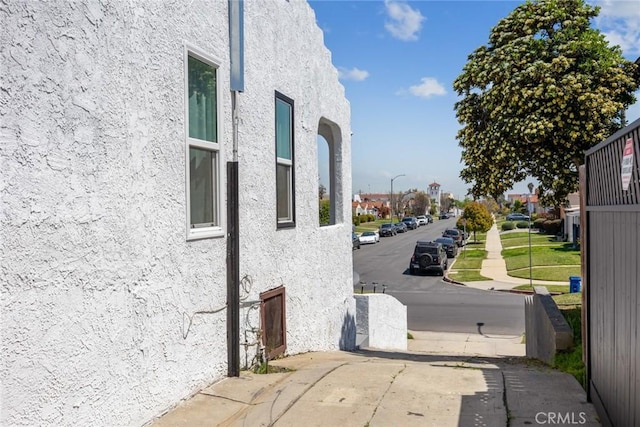 7037 Cimarron St, Los Angeles, CA 90047 - view of asphalt road with street lights, sidewalks, and curbs