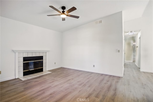 7000 Verdure Way, Elk Grove, CA 95758 - unfurnished living room with a ceiling fan, wood finished floors, baseboards, and a tiled fireplace