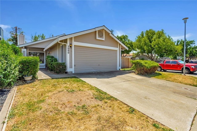 7000 Verdure Way, Elk Grove, CA 95758 - view of front facade with a garage, concrete driveway, stucco siding, and a chimney