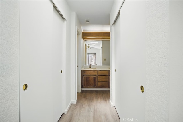 7000 Verdure Way, Elk Grove, CA 95758 - hallway with light wood-style floors, a sink, and baseboards
