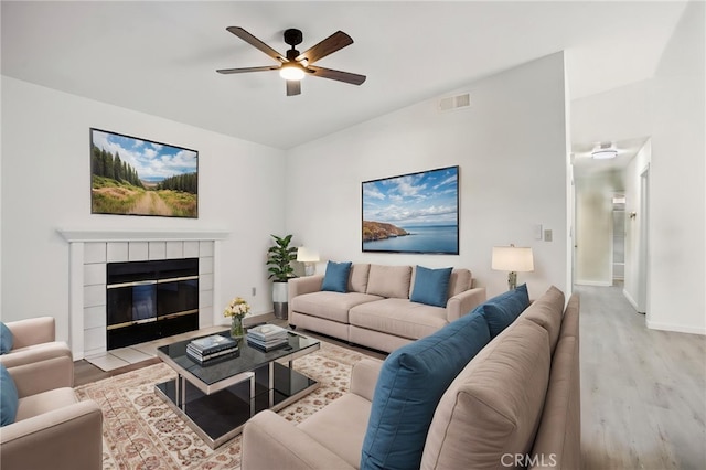 7000 Verdure Way, Elk Grove, CA 95758 - living area with wood finished floors, a ceiling fan, baseboards, and a tiled fireplace