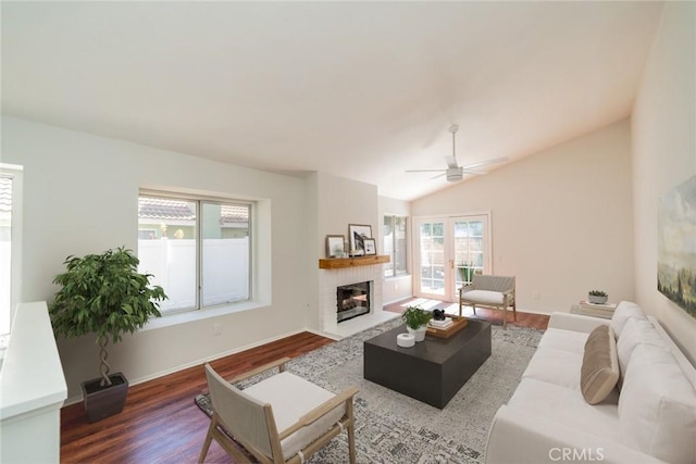 27331 Prominence Rd, Menifee, CA 92586 - living area featuring wood finished floors, ceiling fan, a brick fireplace, lofted ceiling, and baseboards