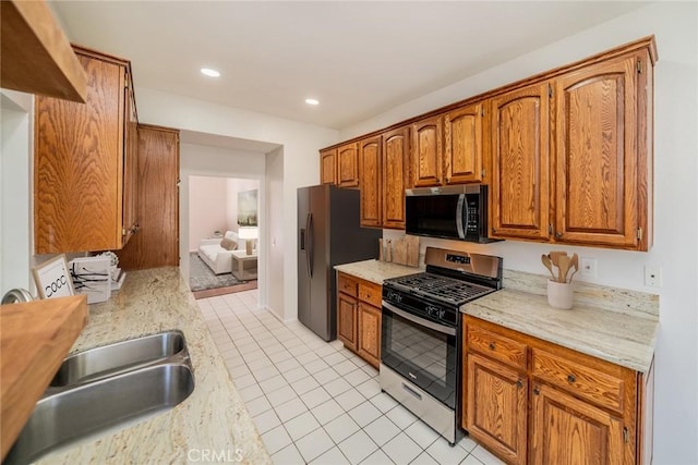27331 Prominence Rd, Menifee, CA 92586 - kitchen featuring appliances with stainless steel finishes, light countertops, light tile patterned flooring, a sink, and recessed lighting