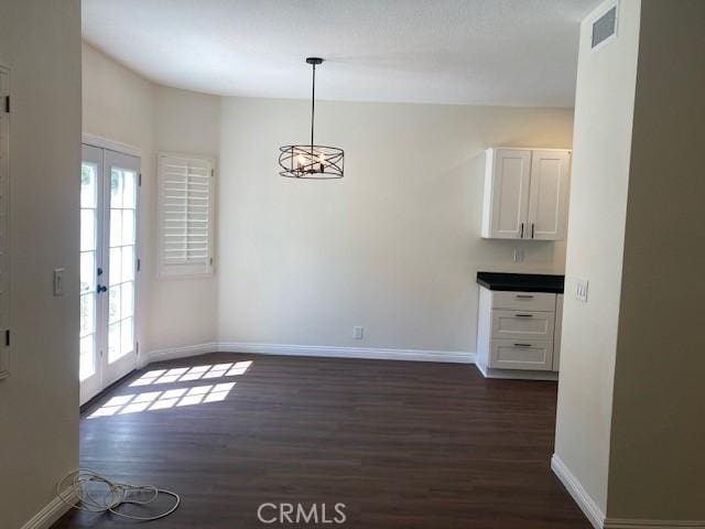 28769 Magnolia Way, Saugus, CA 91390 - unfurnished dining area featuring healthy amount of natural light, dark wood-style flooring, and baseboards