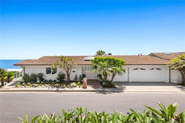 326 Boca Del Canon, San Clemente, CA 92672 - view of front of home with an attached garage, stucco siding, a tile roof, driveway, and a water view