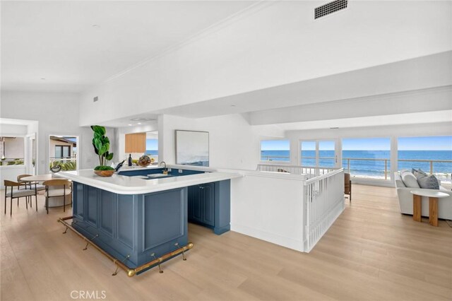 326 Boca Del Canon, San Clemente, CA 92672 - kitchen with light wood finished floors, blue cabinets, light countertops, and a water view