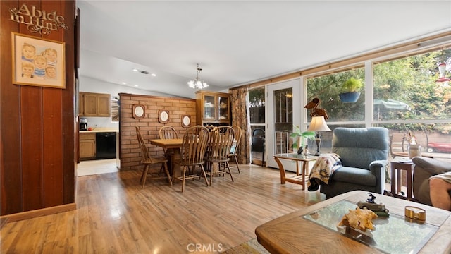 1104 W F St, Ontario, CA 91762 - dining space with light wood-style floors, vaulted ceiling, and a chandelier