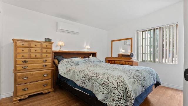 1104 W F St, Ontario, CA 91762 - bedroom featuring a wall mounted AC, wood finished floors, and baseboards