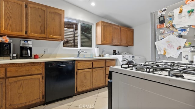 1104 W F St, Ontario, CA 91762 - kitchen with stainless steel appliances, washing machine and clothes dryer, a sink, light tile patterned flooring, and light countertops