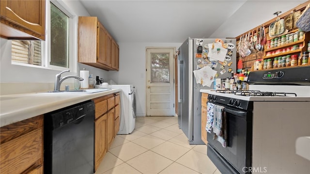 1104 W F St, Ontario, CA 91762 - kitchen featuring white range with gas stovetop, black dishwasher, light countertops, a sink, and light tile patterned flooring
