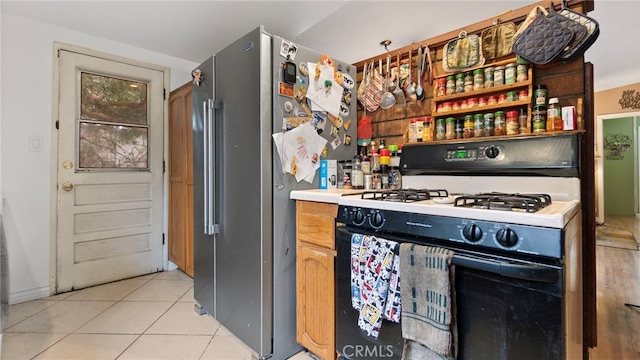 1104 W F St, Ontario, CA 91762 - kitchen with gas range, light tile patterned floors, and freestanding refrigerator