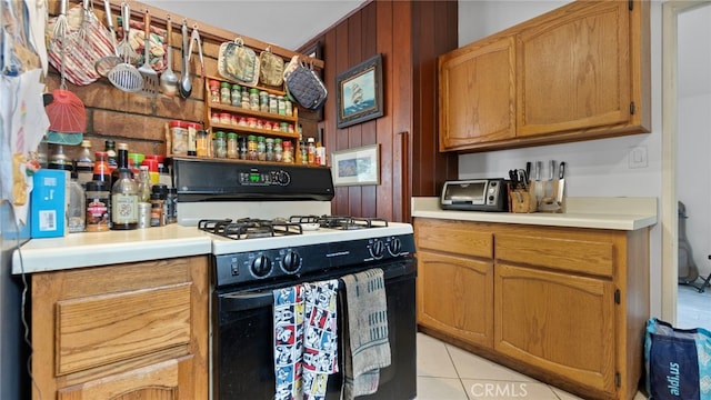 1104 W F St, Ontario, CA 91762 - kitchen featuring range with gas stovetop, light countertops, light tile patterned floors, open shelves, and brown cabinets