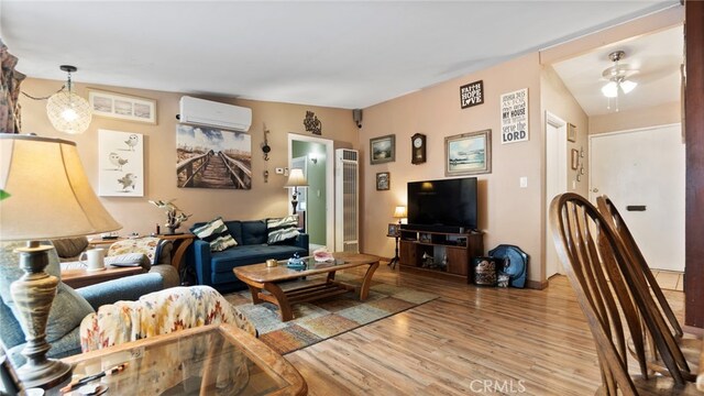 1104 W F St, Ontario, CA 91762 - living area featuring a wall mounted AC, wood finished floors, and a heating unit