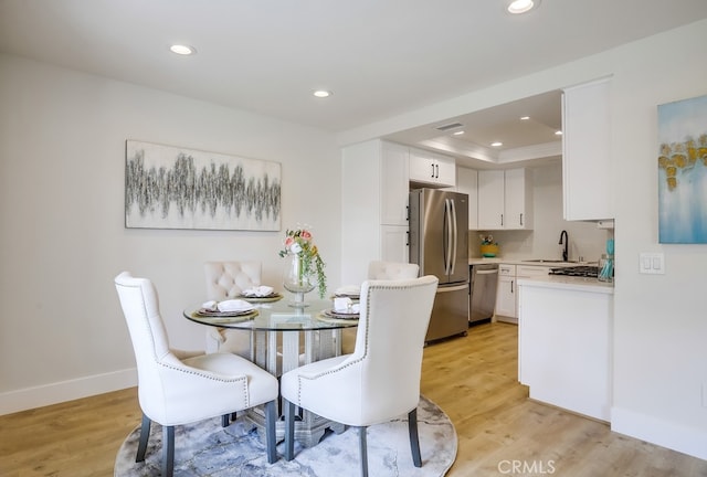 658 S Webster Ave Unit 4, Anaheim, CA 92804 - dining area featuring recessed lighting, light wood-type flooring, a tray ceiling, and baseboards
