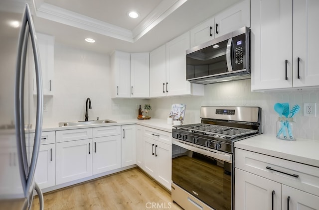 658 S Webster Ave Unit 4, Anaheim, CA 92804 - kitchen with appliances with stainless steel finishes, a sink, light wood finished floors, ornamental molding, and backsplash