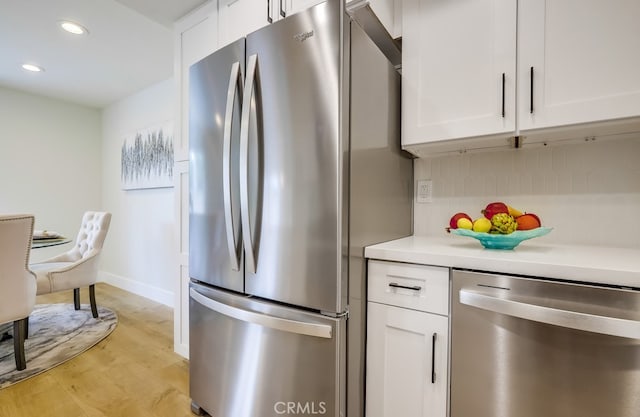 658 S Webster Ave Unit 4, Anaheim, CA 92804 - kitchen with stainless steel appliances, white cabinets, light wood-type flooring, recessed lighting, and light countertops