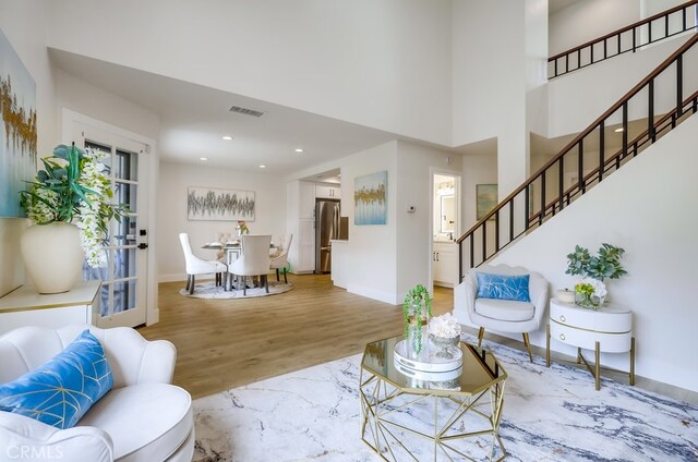 658 S Webster Ave Unit 4, Anaheim, CA 92804 - living room with stairs, wood finished floors, baseboards, recessed lighting, and a towering ceiling